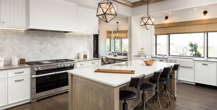 Kitchen interior after a Fine Set Tile remodel with new tile backsplash, cabinets, and improved layout
