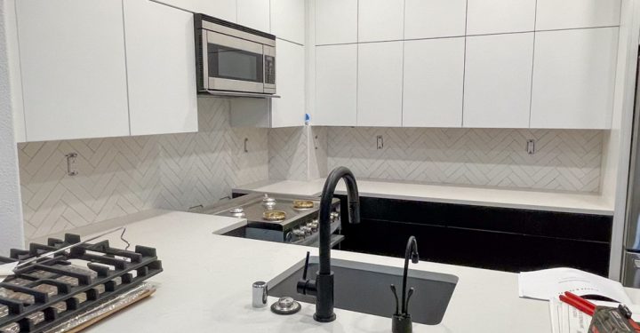 Tiles for kitchen backsplash, marble countertop, and white kitchen cabinets