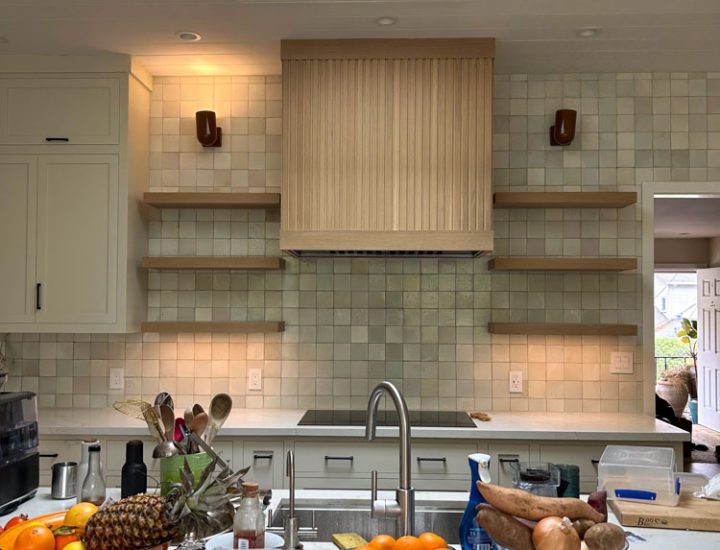 A kitchen remodeled with tile backsplash and wall-mounted shelves
