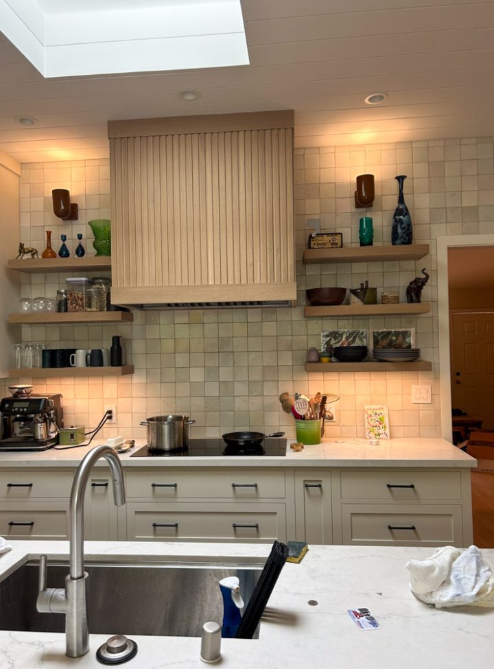 A kitchen remodeled with tile backsplash and wall-mounted shelves